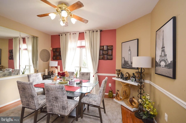 dining room with hardwood / wood-style floors and ceiling fan