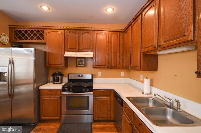 kitchen featuring appliances with stainless steel finishes, dark wood-type flooring, and sink