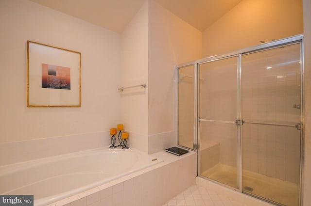 bathroom featuring plus walk in shower and vaulted ceiling