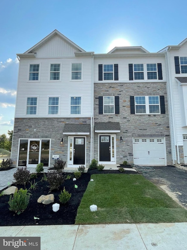 view of front of home with a front yard and a garage