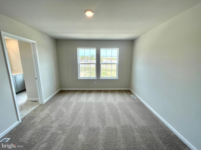 empty room featuring light colored carpet