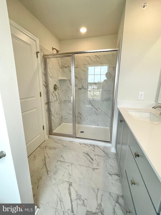 bathroom with vanity and a shower with shower door