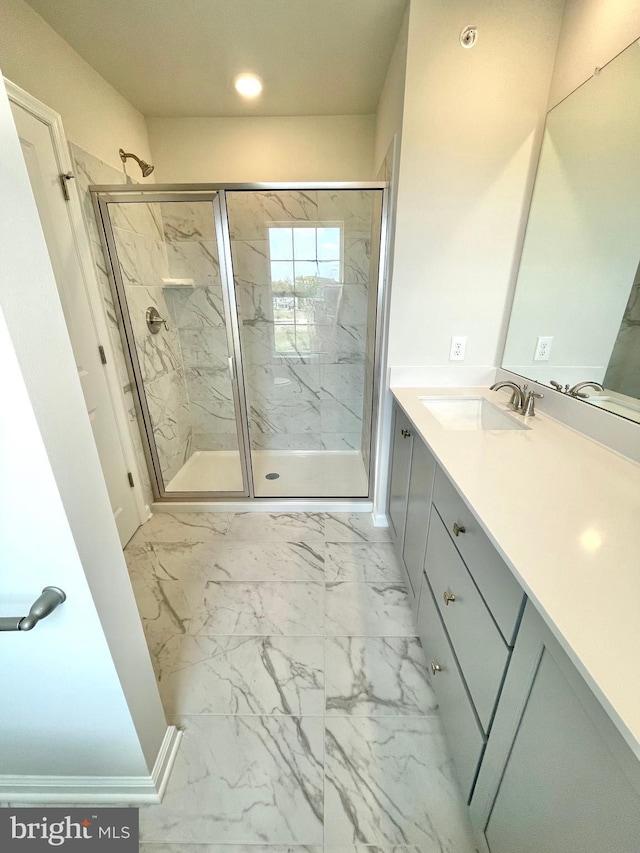 bathroom featuring vanity and an enclosed shower