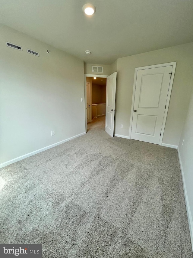 empty room featuring light colored carpet