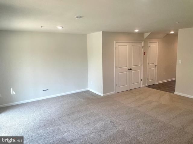 empty room featuring dark carpet