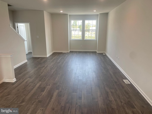 spare room featuring dark hardwood / wood-style flooring