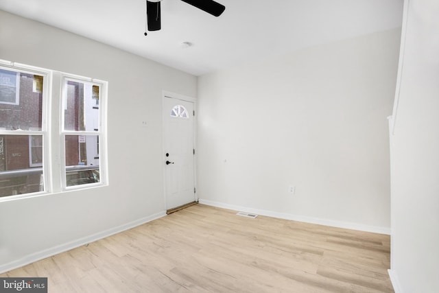 spare room with light wood-type flooring and ceiling fan