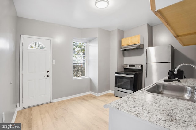 kitchen featuring light hardwood / wood-style floors, light brown cabinetry, sink, and appliances with stainless steel finishes