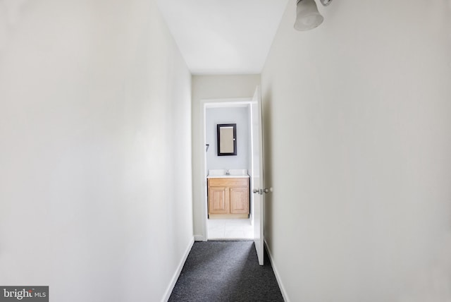 corridor with sink and carpet floors