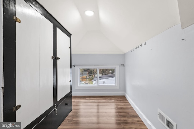 additional living space featuring lofted ceiling and wood-type flooring