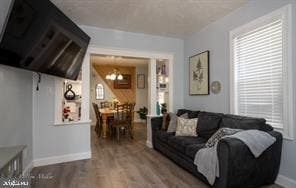 living room with hardwood / wood-style floors and a chandelier