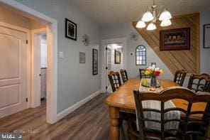 dining room featuring an inviting chandelier and hardwood / wood-style flooring