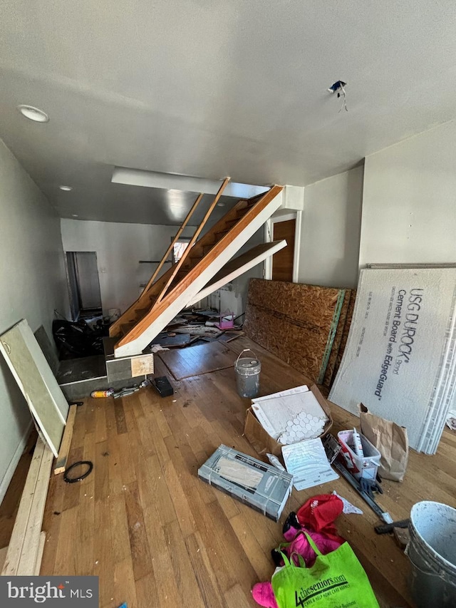 interior space with a textured ceiling and hardwood / wood-style flooring