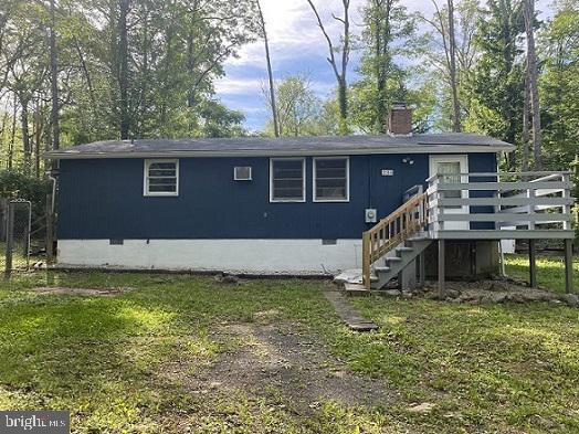 back of house with a wooden deck