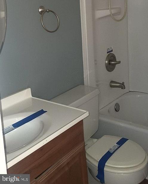 full bathroom with shower / tub combination, vanity, and toilet