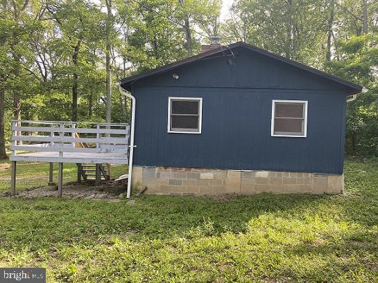 view of side of property featuring a deck