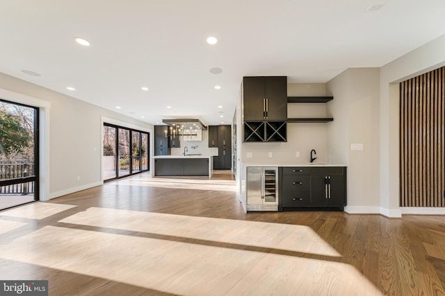 bar featuring light hardwood / wood-style floors and wine cooler