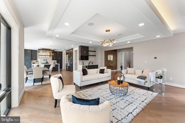 3113 Circle Hill Rd, Alexandria, VA 22305 - living area with a chandelier, recessed lighting, a raised ceiling, baseboards, and light wood-style floors