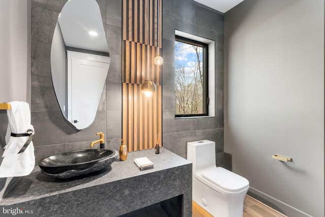3113 Circle Hill Rd, Alexandria, VA 22305 - bathroom with tile walls, toilet, wood finished floors, baseboards, and vanity