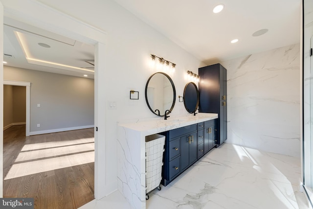 bathroom featuring wood-type flooring, vanity, and ceiling fan