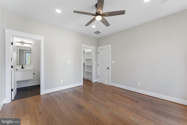 3113 Circle Hill Rd, Alexandria, VA 22305 - unfurnished bedroom with baseboards, wood finished floors, recessed lighting, ensuite bath, and a spacious closet