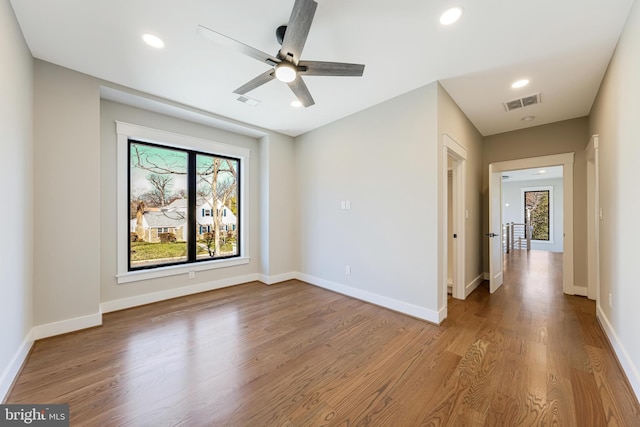 spare room featuring ceiling fan and hardwood / wood-style floors