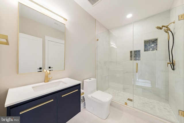 bathroom featuring toilet, vanity, and walk in shower