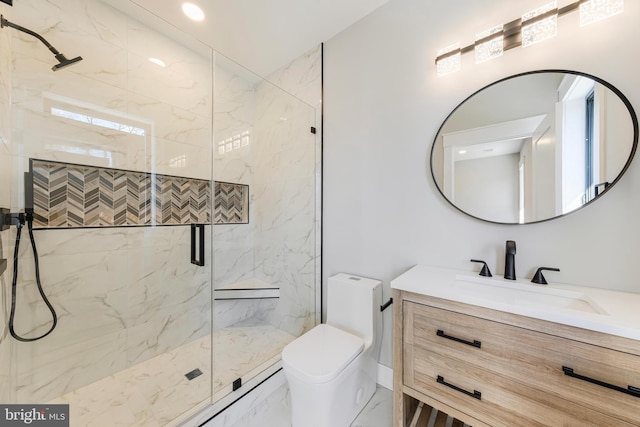 bathroom with vanity, toilet, and a shower with shower door