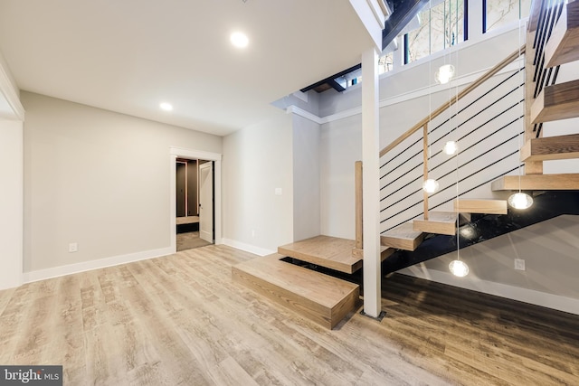 stairway featuring wood-type flooring