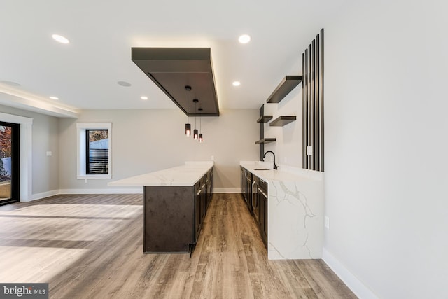 3113 Circle Hill Rd, Alexandria, VA 22305 - bar with dark brown cabinetry, sink, and light hardwood / wood-style flooring