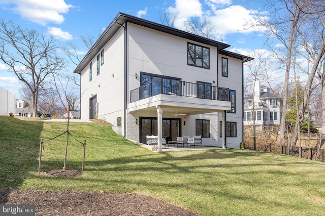 3113 Circle Hill Rd, Alexandria, VA 22305 - back of property featuring a balcony, a patio area, a yard, and stucco siding