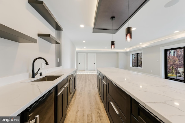 3113 Circle Hill Rd, Alexandria, VA 22305 - kitchen with dishwasher, sink, hanging light fixtures, light hardwood / wood-style flooring, and light stone countertops
