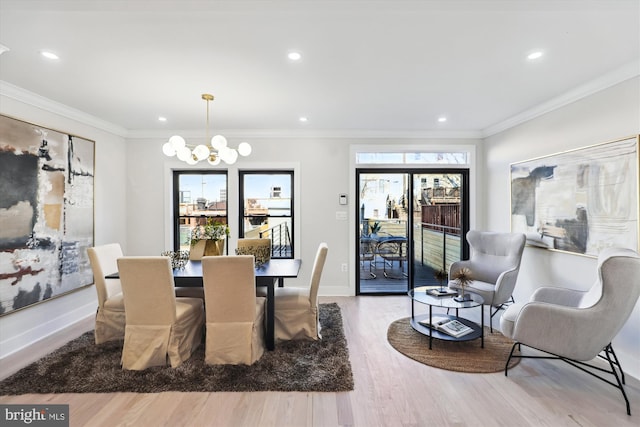 dining area featuring hardwood / wood-style floors, a healthy amount of sunlight, and ornamental molding