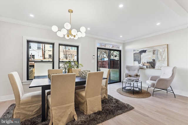 dining space with light hardwood / wood-style floors and ornamental molding