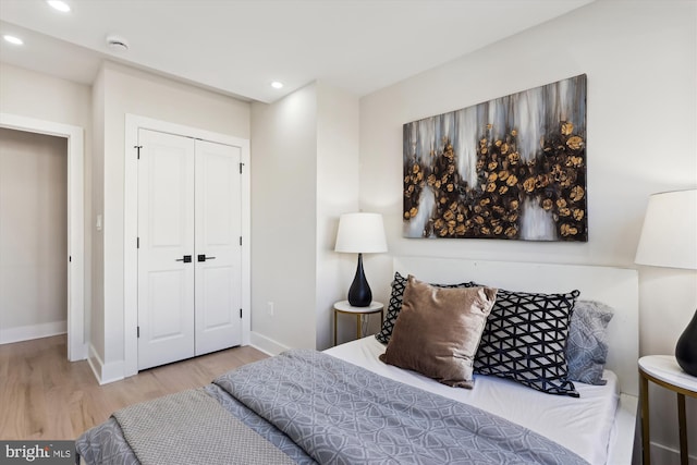 bedroom with hardwood / wood-style floors and a closet