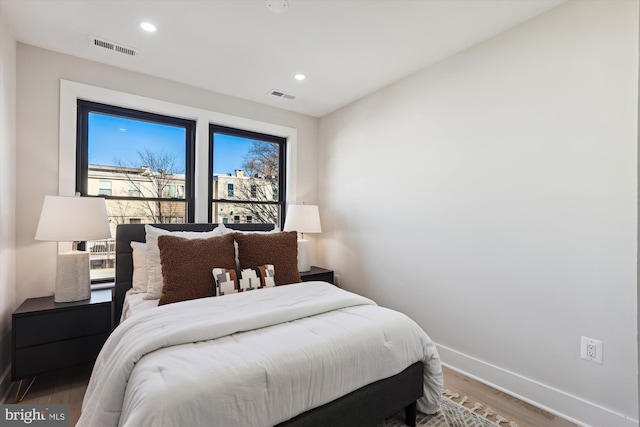 bedroom with hardwood / wood-style floors