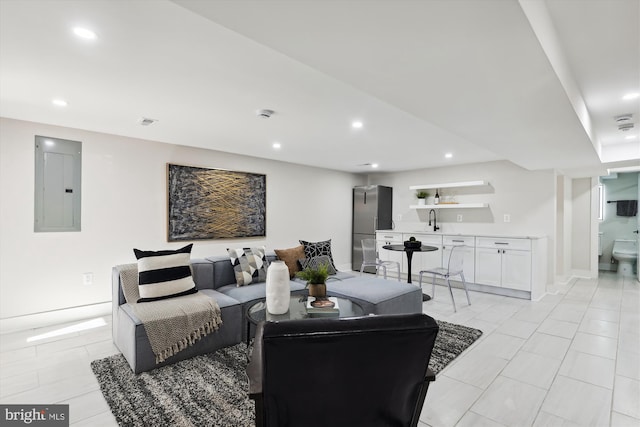 living room featuring sink and electric panel