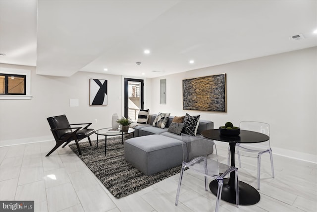 living room with electric panel and plenty of natural light