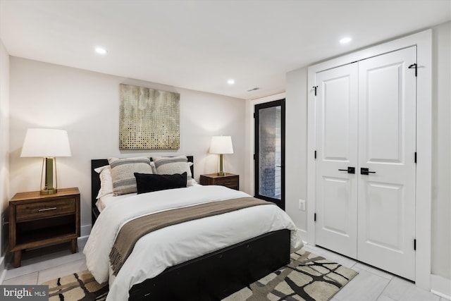 tiled bedroom featuring access to outside and a closet