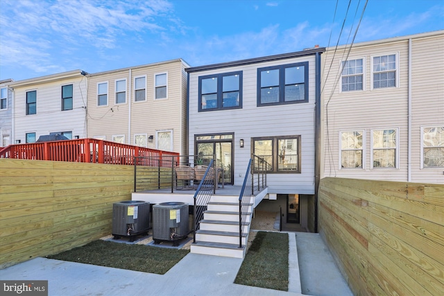 back of house with central AC unit