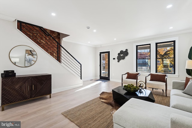 living room featuring light hardwood / wood-style flooring and crown molding