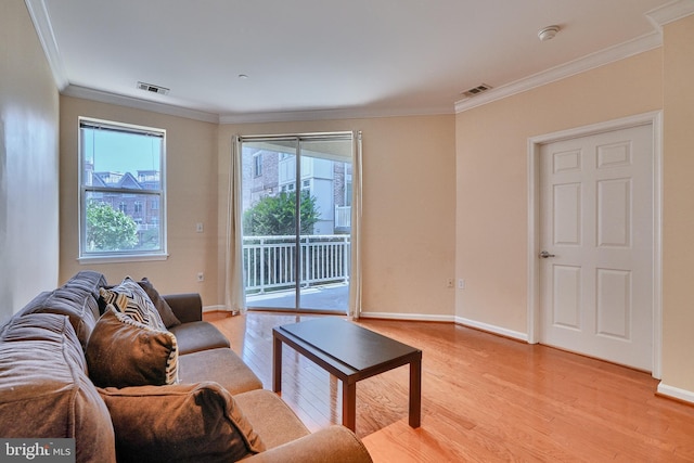 living room with light hardwood / wood-style floors and ornamental molding