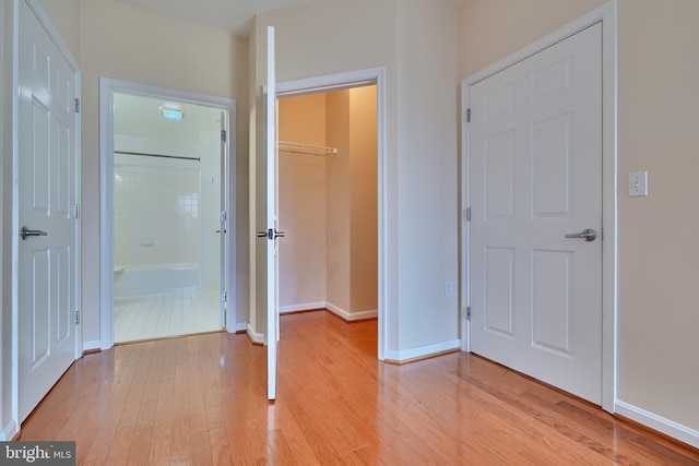 hallway with light hardwood / wood-style floors