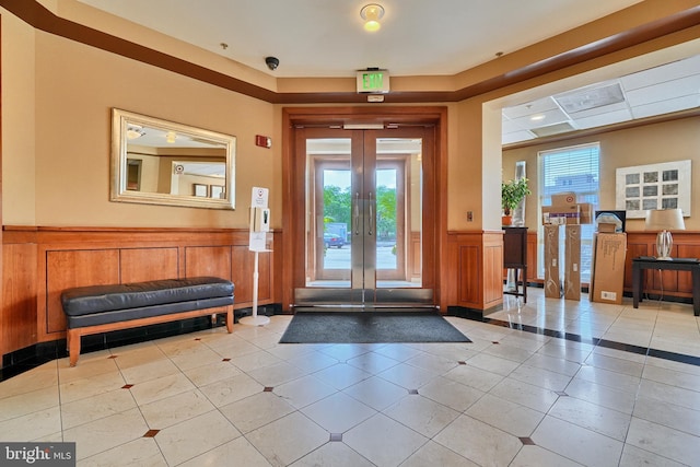 entrance foyer featuring french doors and light tile patterned flooring