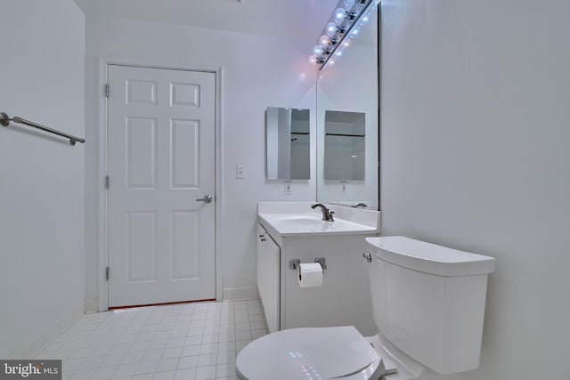 bathroom with tile patterned flooring, vanity, and toilet