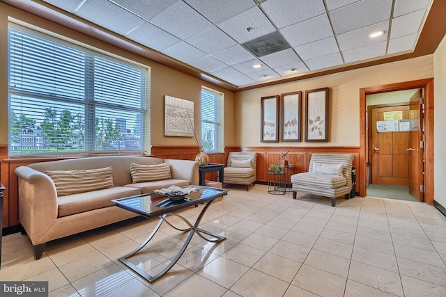 tiled living room with a drop ceiling