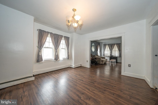 unfurnished room with dark hardwood / wood-style flooring, an inviting chandelier, and baseboard heating