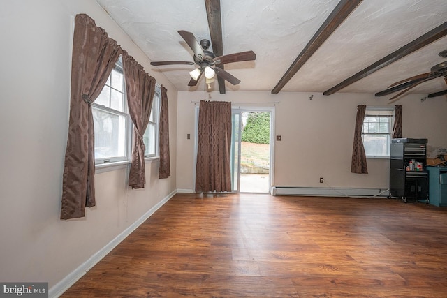 unfurnished room featuring ceiling fan, beamed ceiling, dark wood-type flooring, and a baseboard radiator