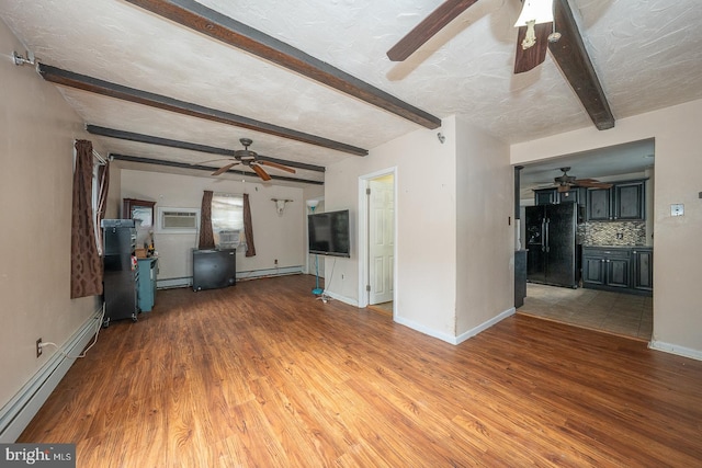 unfurnished living room featuring hardwood / wood-style floors, a textured ceiling, and a baseboard heating unit