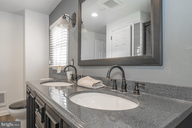 bathroom featuring vanity and toilet